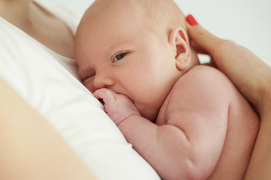 closeup-of-newborn-baby-boy-sleeping-on-his-mothers-chest